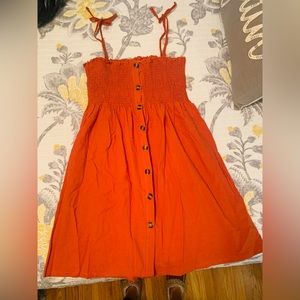 Dark orange smocked dress with wooden buttons (functional)